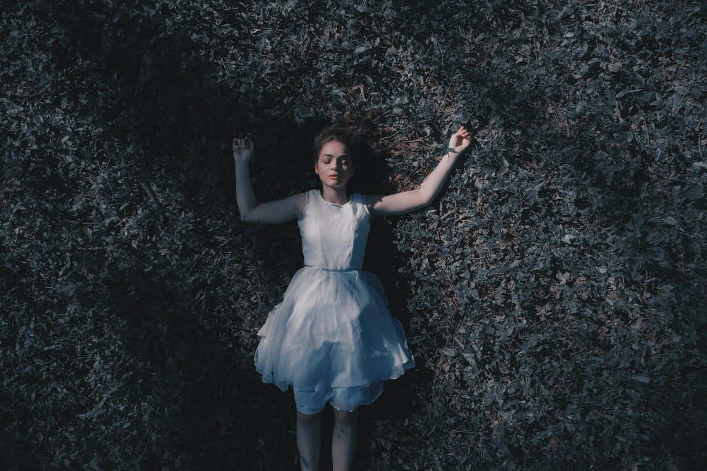 Woman Laying Down On Ground